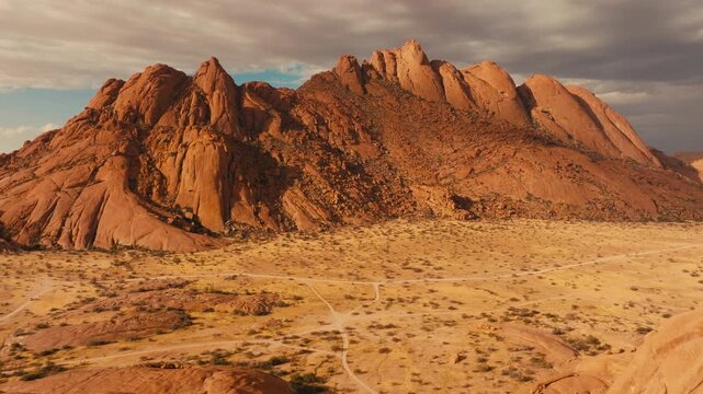 Drone shot over Spitzkoppe in Namibia desert sunset cinematic