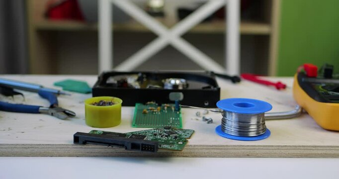 Engineering workspace with electronic components, soldering tools, and measurement equipment on workbench. Concept of hardware development, circuit design, and professional technical work.