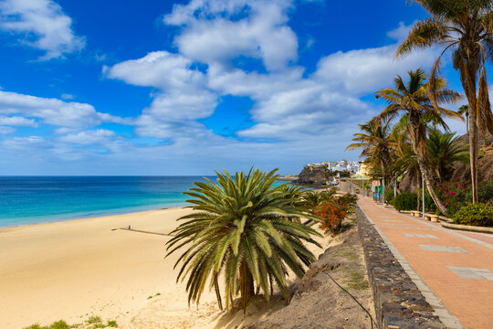 Panoramic view of a sandy beach with turquoise ocean under a blue sky, Morro Jable, Canary Island, Fuerteventura, background or wallpaper for your project   