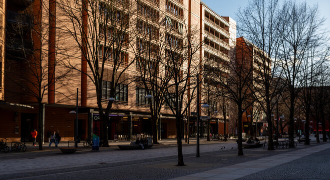 Modern urban street scene at Potsdamer Platz in Berlin with pedestrians, bicycles and contemporary architecture