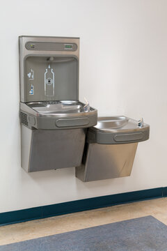 Modern drinking water fountain with bottle filling station on wall