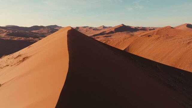 Drone shot over sand dunes in Namibia national park Sossuvlei with cinematic sunset