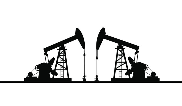 Silhouette of two oil pump jacks in operation at dusk