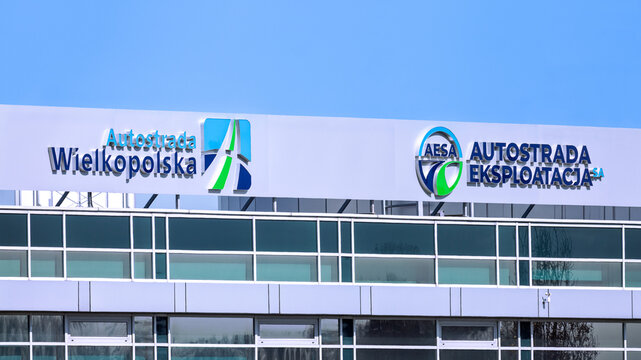 Poznan, Poland - March 27, 2026. Logos of Autostrada Wielkopolska and Autostrada Eksploatacja - companies operating the concession section of the A2 motorway in western Poland.