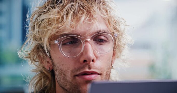 Creative, online and businessman with laptop in office, proofreading and editing article on website. Magazine editor, glasses and person with tech for media publication, vision or review in newsroom
