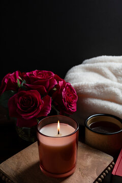 Warm candlelight beside a cup of Coffee, and a soft blanket creates a cozy romantic self-care setting. This intimate scene evokes relaxation, mindfulness, and quiet moments, perfect for Valentine&rsquo;s Da
