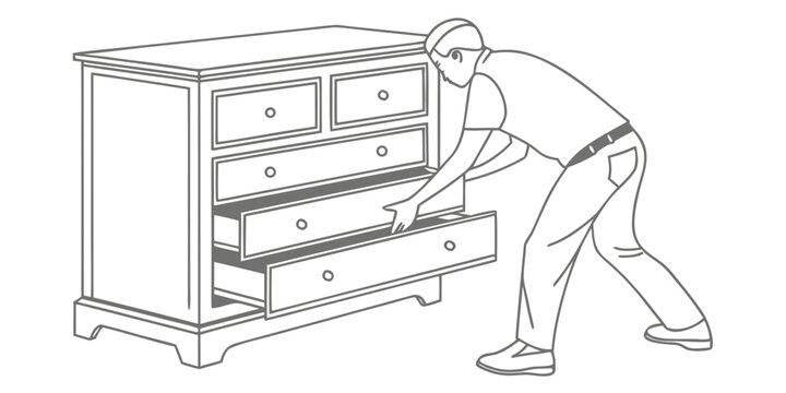 Man bending down to open the bottom drawer of a wooden dresser
