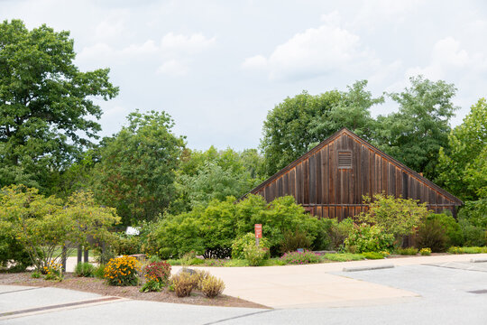 Wooden building surrounded by gardens and trees