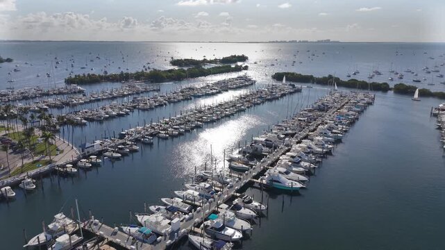 Large marina with sun light making strong reflections on the ocean water