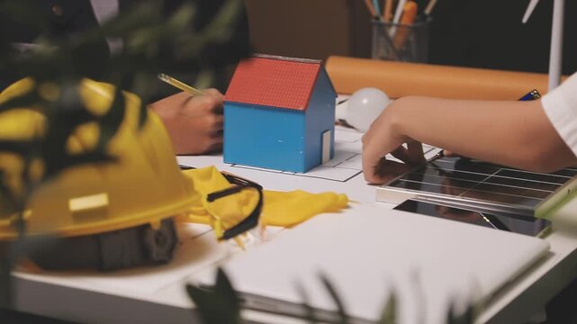 Construction engineers discussing project in office