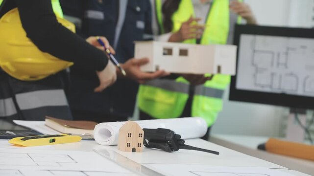 Construction engineers discussing project in office