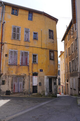 Fototapeta premium Historic yellow facade of an old house in Thiers, France, authentic French architecture
