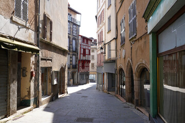 Obraz premium Medieval street in Thiers, France, with stone arches and half-timbered houses, Europe