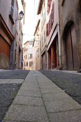 Fototapeta premium Narrow cobblestone street with old buildings in Thiers, Puy-de-Dome, France