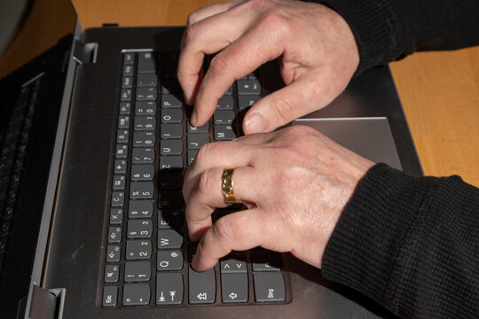 topview of hands typing on a keyboard