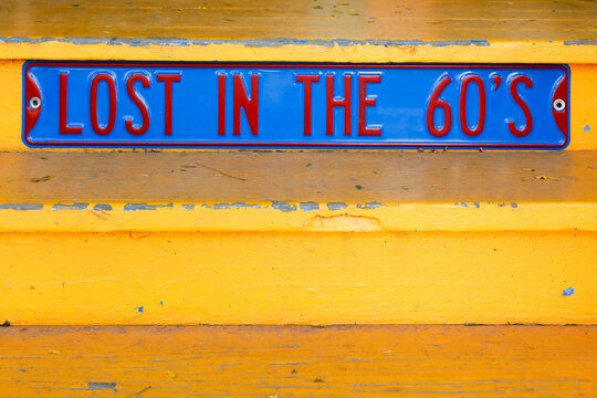 Lost in the 60s Vintage Sign on Weathered Yellow Background