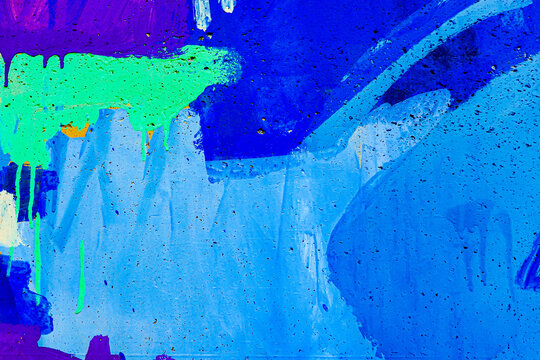 Light blue, purple, neon green bush strokes, paint drips, flows, streaks on wall outdoors
