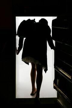 Silhouette of Woman Entering Light Through Doorway Concept of Opportunity or Transition
