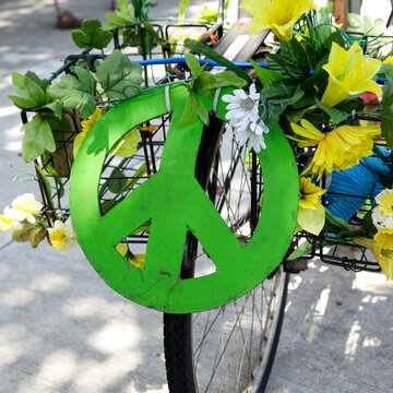 Green Peace Symbol Attached to Bicycle with Flowers