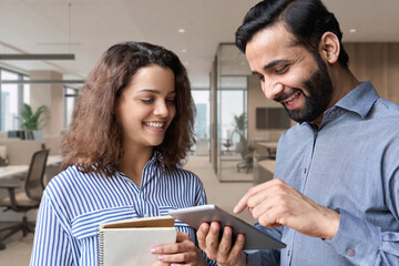 Diverse friendly coworkers colleagues indian male manager and latin female employee talking in...