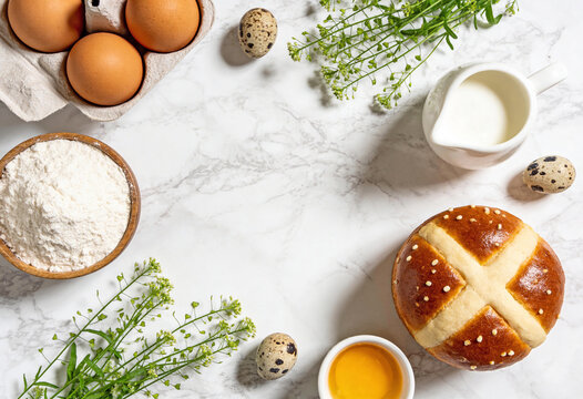 Easter cooking background with eggs, flour and herbs on marble surface