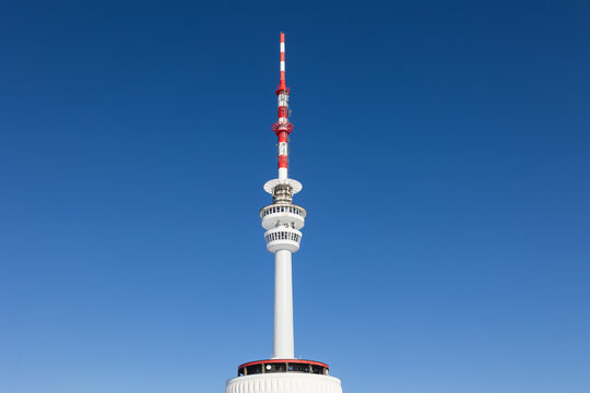 Television and communications tower and transmitter, Praded, Jeseniky mountains, Czech Republic, Czechia. Detail of tall utility building. Clear blue sky as copy space.