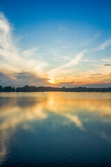 Fototapeta premium spectacular sunrise with its reflection in the still water