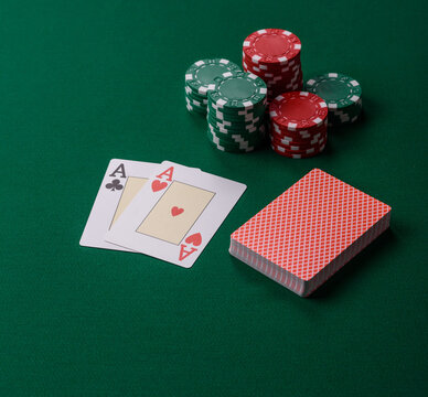 Playing cards and chips on a green cloth, a gambling game of blackjack or baccarat. Cards and chips