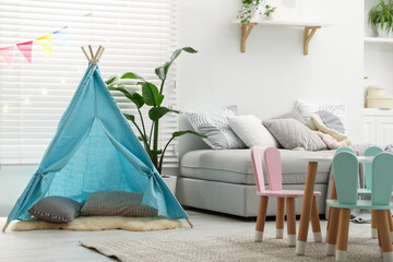 Child's room with furniture, toy wigwam and colorful flags. Interior design © New Africa
