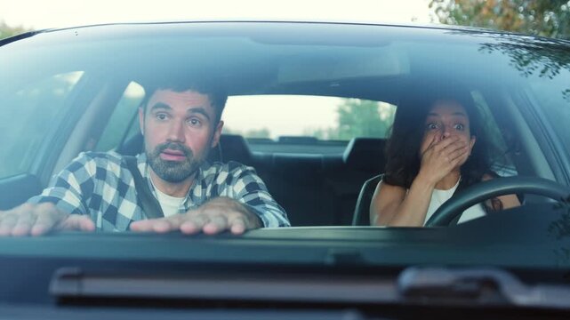 Scared couple inside car get a drive accident. Slow motion