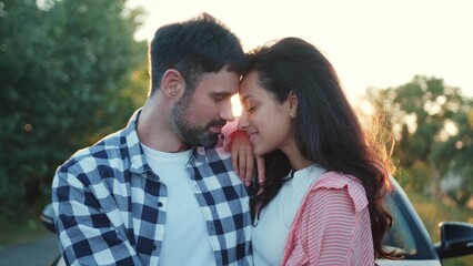 Obraz premium Happy couple during the romantic date on the sunset outdoors. Slow motion