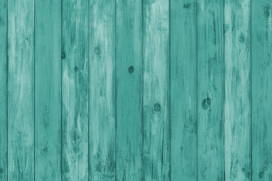 Turquoise colored painted wooden board with visible grain and vertical planks, wall wooden surface. Rustic wood texture background, design element, wallpaper, backdrop