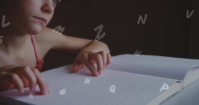 A girl is reading a braille book in a classroom