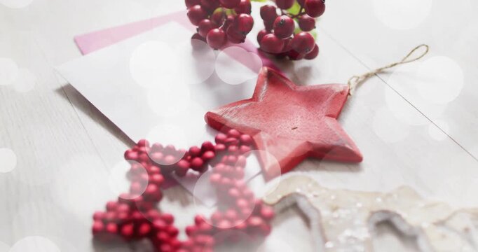 Christmas decorations with red star and berries over bokeh lights animation