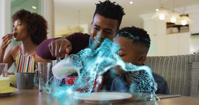 Father pouring milk into son cereal bowl for breakfast, causing glowing aqua particles swirling