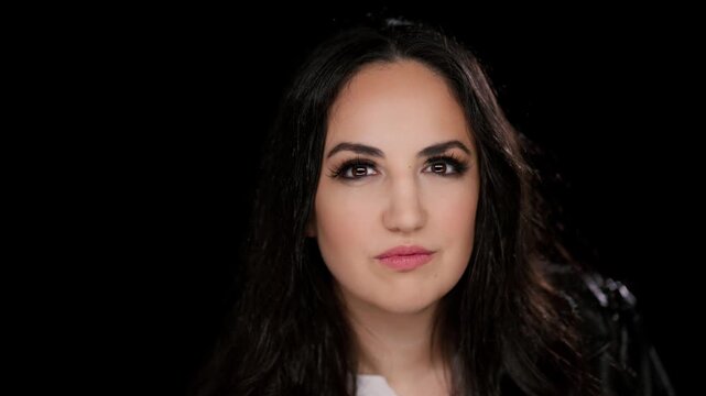 About beauty and self-esteem a young woman posing in a studio setting against a black backdrop The clip is commercial projects advertising campaigns documentaries and news segments The subject is.