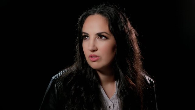 Mental health and vulnerability A woman is talking about her feelings on a dark background in an interview style shot documentary or commercial projects The clip can be used to illustrate topics like.