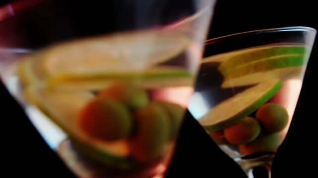 Video of glasses of martini on black background
