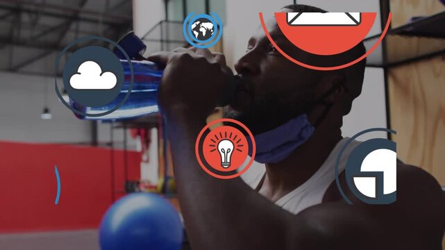 Animation of media icons over african american man drinking water