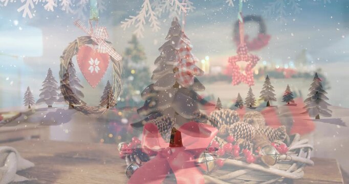 Digital video depicts a snowy scene with fir trees and a decorated wreath.