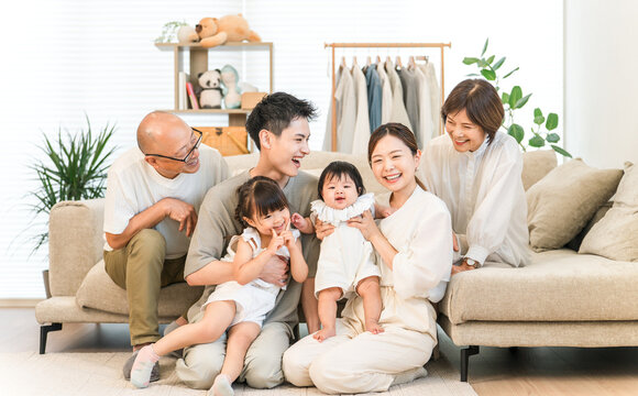 A three-generation family relaxing in the living room.