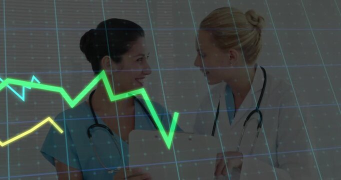Nurse holding tablet and doctor pointing at chart with animated graphs guiding medical discussion