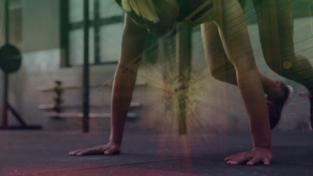 Woman training in gym on start, pressing up, bringing feet forward and jumping under radial overlay