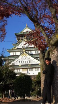 Japanese castle surrounded by colorful autumn trees