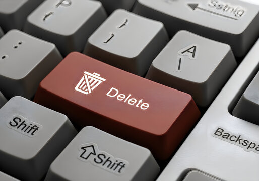 Close-up of red delete key on computer keyboard with backspace and shift buttons for data removal concept