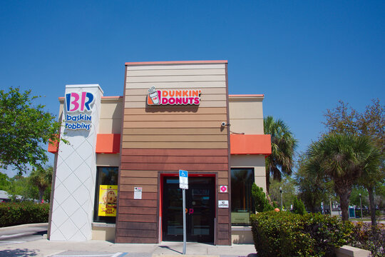 Dunkin' Donuts And Baskin-Robbins Storefront Outside Coffee And Ice Cream Shop On Sunny Day  Editorial Use Only March 27, 2026 St. Petersburg, FL, USA. Exterior retail scene conveying convenience, foo