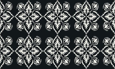 Fototapeta premium Classic black and white ornamental floral pattern with intricate symmetrical motifs. Elegant seamless repeating design, ideal for textile, fabric, and wallpaper.