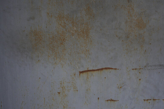 Rusty metal surface with brown oxidation spots