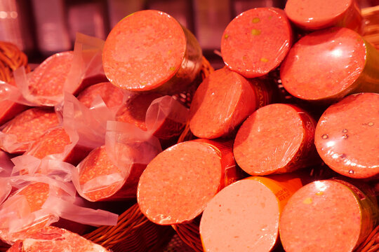 Meat products on display in a market setting during the day