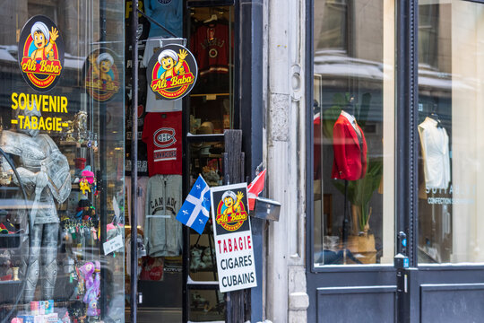 Canada, Montreal, 24 December 2025 : Colorful souvenir shop facade with signs flags and clothing